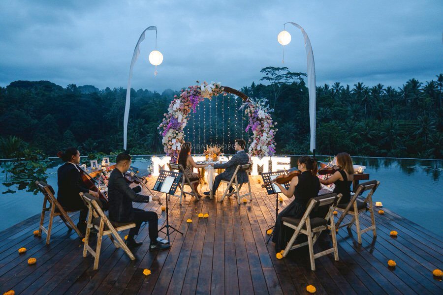 Surprise proposal with string quartet on a jungle pool deck